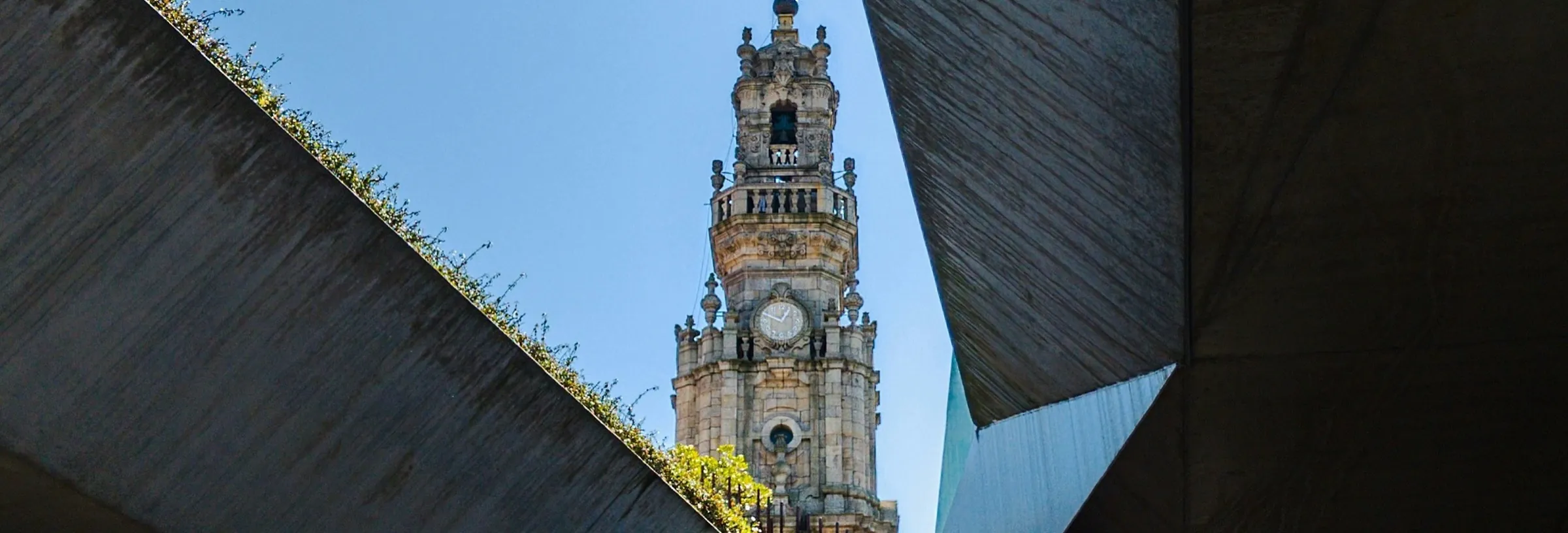 The Clérigos tower in Porto, framed between concrete slabs.